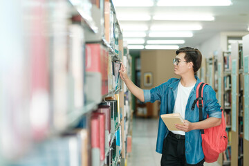 Student reading book at library.