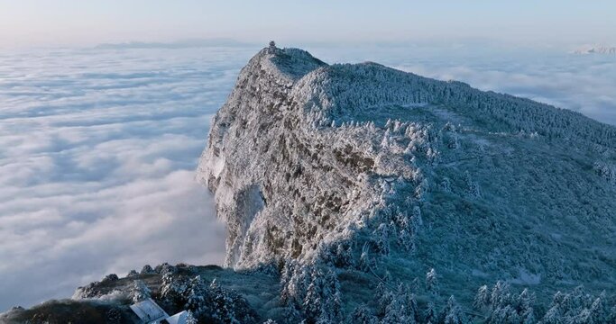 aerial top view of Emei mountain golden summit above the clouds in winter snow day