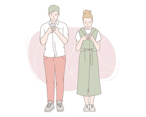 Young couple playing on mobile phones. Premium Vector