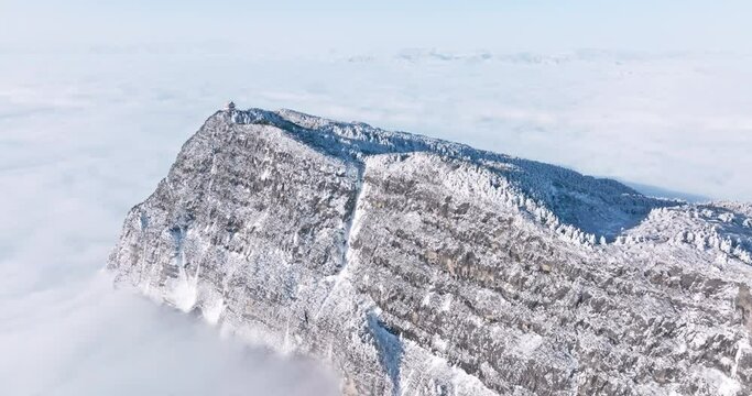aerial top view of Emei mountain golden summit above the clouds in winter snow day