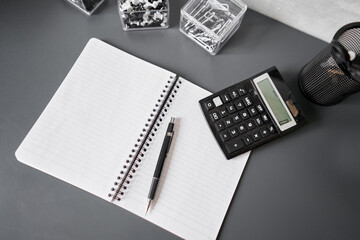 Office desk table with supplies, paper, calculator. Top view with copy space. Selective focus. Business Financing Accounting Banking Concept