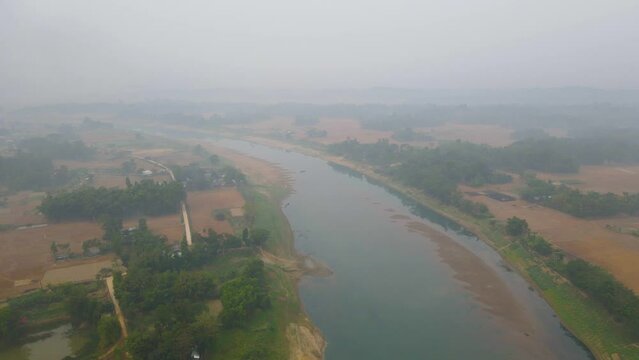 flying through thick morning fog over Surma river in Bangladesh