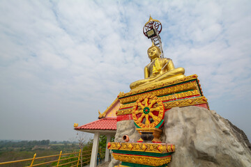 Fototapeta na wymiar The golden Buddha statue at Tham Champathong monastery, Ratchaburi, Thailand