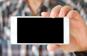 Man holding and showing a smartphone with a black screen and empty items in hand And his screen is showing free copy space for your ads. Technology concept