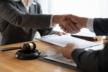 Lawyers shake hands with business people to seal a deal with partner lawyers. or a lawyer discussing contract agreements, handshake concepts, agreements, agreements