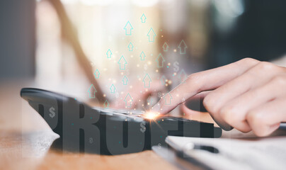 Investors use a calculator to calculate investment profits ,Increase profits and wealth ,Profitable growth in business and investment ,progress in development financial performance and investment