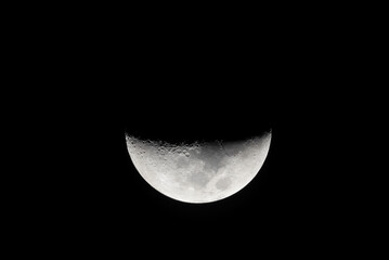 Night sky background with half of the moon on black sky. Astro photo on winter night with soft selective focus