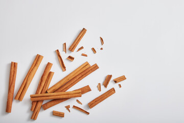 Top view of cinnamon sticks (Cinnamomum) isolated on white background. Space for text and design. Background for organic cosmetic concept, cinnamon extract.