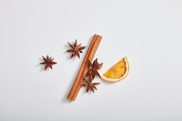 Top view, flat lay of cinnamon stick, anise and dried orange slice isolated on white background. These are herbs good for health, heart, skincare and haircare.