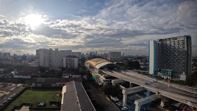 city ​​view of jakarta indonesia, tall buildings with moving clouds and sunrise in the background. timelapse videos