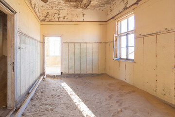 Kolmanskop, The abandoned houses. the famous tourist attraction in Namibia, South Africa. Empty sand dune in home room . The ghost town.