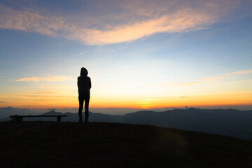 silhouette woman standing on mountain in morning and vintage filter, Feast hiking. Deep thought....