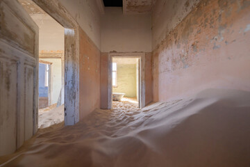 Kolmanskop, The abandoned houses. the famous tourist attraction in Namibia, South Africa. Empty sand dune in home room . The ghost town. - obrazy, fototapety, plakaty