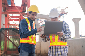 Construction Engineer using computer inspection on site highway road construction, Construction worker using laptop