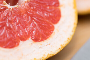 Defocused blurred cut grapefruit macro texture close up with orange grapefruit skin