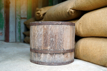 Thai Wooden bucket are used for measuring. Placed on a sack of rice. The bucket unit is a unit of measurement in Thailand in ancient times, with 1 bucket equal to 20 kilograms.