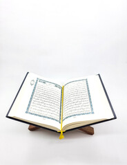 Fototapeta na wymiar Ramadan Kareem, Eid Mubarak or Islamic concept. The Islamic holy book, Quran or Kuran, on grey background. Arabic words on the book means 