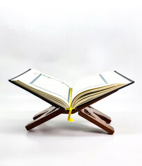 Ramadan Kareem, Eid Mubarak or Islamic concept. The Islamic holy book, Quran or Kuran, on grey background. Arabic words on the book means 