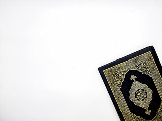 Ramadan Kareem, Eid Mubarak or Islamic concept. The Islamic holy book, Quran or Kuran, on grey background. Arabic words on the book means "Holy Quran".