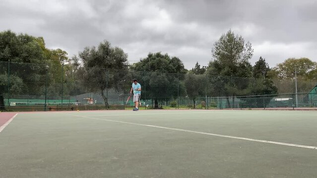Tennis Player Servers by Smash Hitting Ball with a Racquet During Match. Professional Athlete Strikes Cool