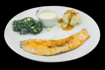 Top view of Grilled Salmon Steak with Spinach with Cream sauce, focus selective