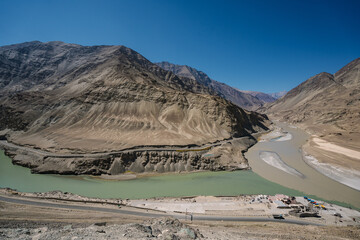 beautiful landscape of mountain and river at Sangam – the confluence of the Indus river (green...