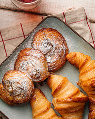 Freshly baked croissants and buns with tea