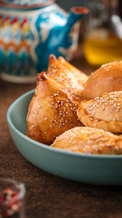 Portion of assorted uzbek baked samsa pies with sesame