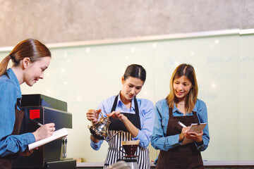 An experienced female barista in uniform will demonstrate how coffee is made and provide a master class. Small business and cafe owner concept