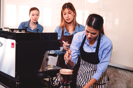 An experienced female barista in uniform will demonstrate how coffee is made and provide a master class. Small business and cafe owner concept