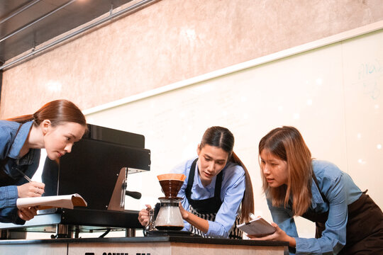 An experienced female barista in uniform will demonstrate how coffee is made and provide a master class. Small business and cafe owner concept