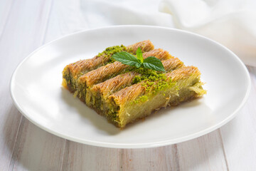 Turkish famous dessert burma kadayif on plate with pistachio