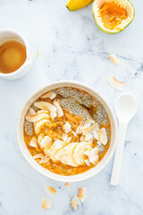 Chia pudding with passion fruit, coconut and coconut yogurt in bowl. Healthy vegan recipe.