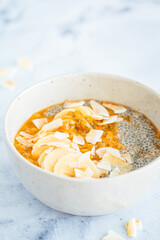 Chia pudding with passion fruit, coconut and coconut yogurt in bowl. Healthy vegan recipe.
