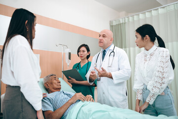 Fototapeta premium professional doctor standing by explain the treatment information via male elderly patient lying in bed in private hospital sickroom. The treatment program is suitable for people to socialize elderly