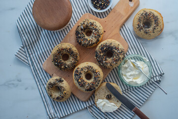 home made whople grain Bagels with cheese on a table