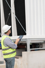 Industry engineer under checking the industry cooling tower air conditioner is water cooling tower...