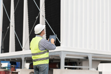 Industry engineer under checking the industry cooling tower air conditioner is water cooling tower...