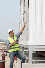 Industry engineer under checking the industry cooling tower air conditioner is water cooling tower...