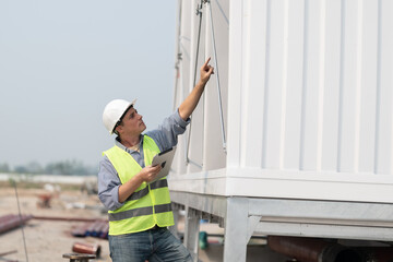 Industry engineer under checking the industry cooling tower air conditioner is water cooling tower...