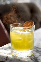 cocktail drink with ice, Beautiful golden dust in a cocktail glass. Gold