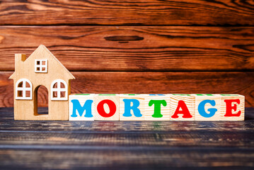 Wooden home and text on the cubes  mortgage
