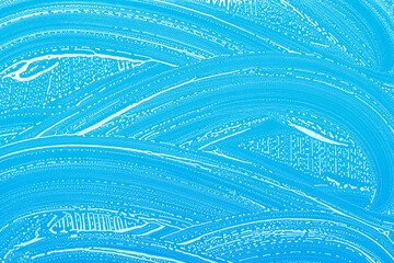 soap foam on blue background, window cleaning, abstract pattern