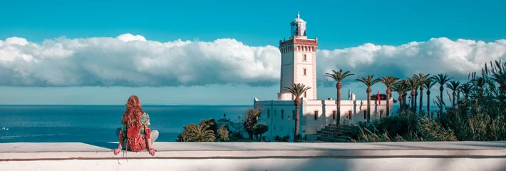  Woman tourist looking at lighthouse of Cap Spartel, Tanger, Morocco in Africa © M.studio