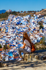 Fototapeta na wymiar View of the blue city of Chefchaouen in Morocco and traveler woman