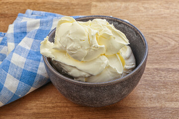 Italian soft mascarpone cheese in the bowl