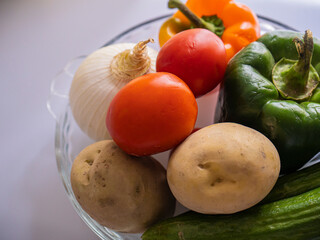 Pepper . tomato . Cucumber . potato . an onion . Garlic . raw .