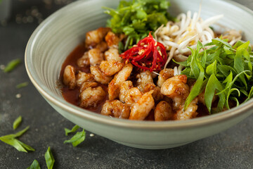 chicken pieces in batter in hot sauce with chili and soy sprouts, Asian cuisine