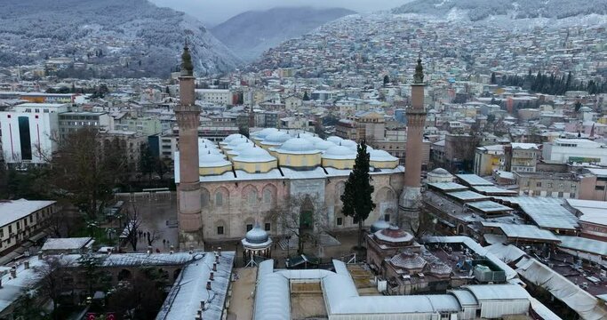 Historic Mosque In Winter Landscape At The Grand Mosque of Bursa In Turkey. Aerial Drone Shot