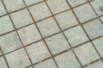 Geometric patten on sidewalk or driveway for texture with square cement blocks and small gaps between